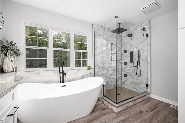 Bathroom remodeling idea featuring a shower with a standalone tub by SemBro Design & Supply