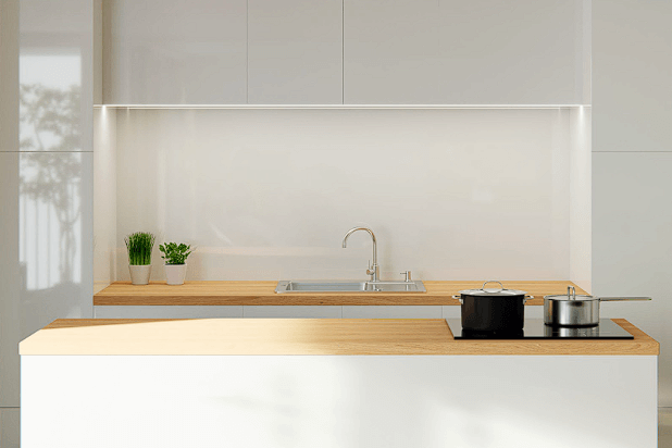 A minimalistic kitchen featuring a white kitchen countertop